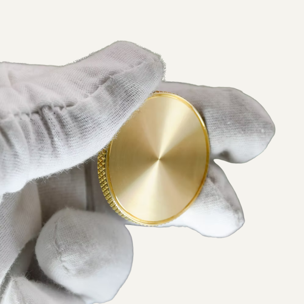 Hand holding a Custom Brass Ball Marker showcasing its knurled edge and premium finish.