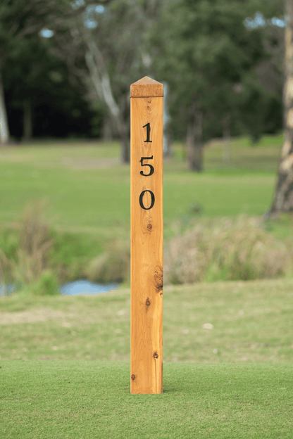 Cypress Distance Marker Post featuring a 150 meter marker made from Australian timber on a golf course.